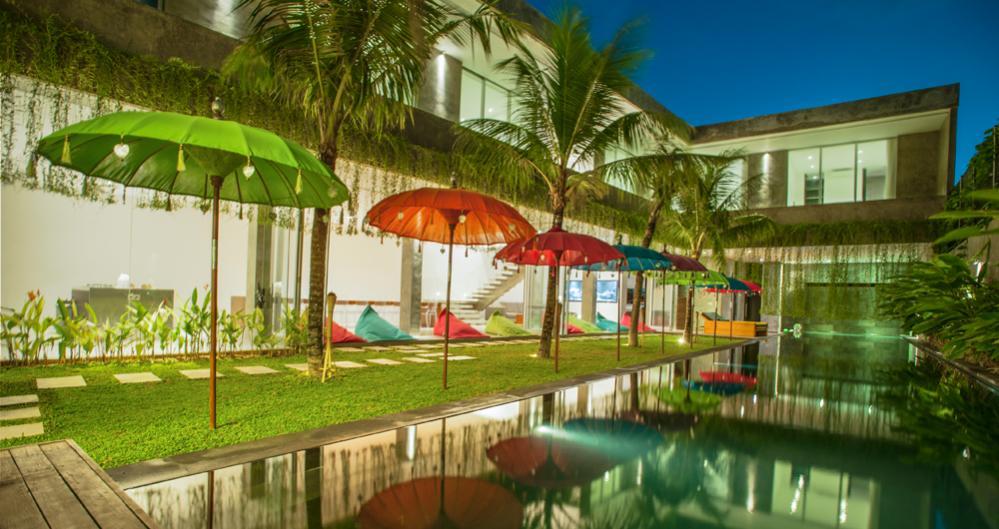 Our 25 metre saltwater pool with waterfall surrounded by relaxing sun decks and tropical gardens